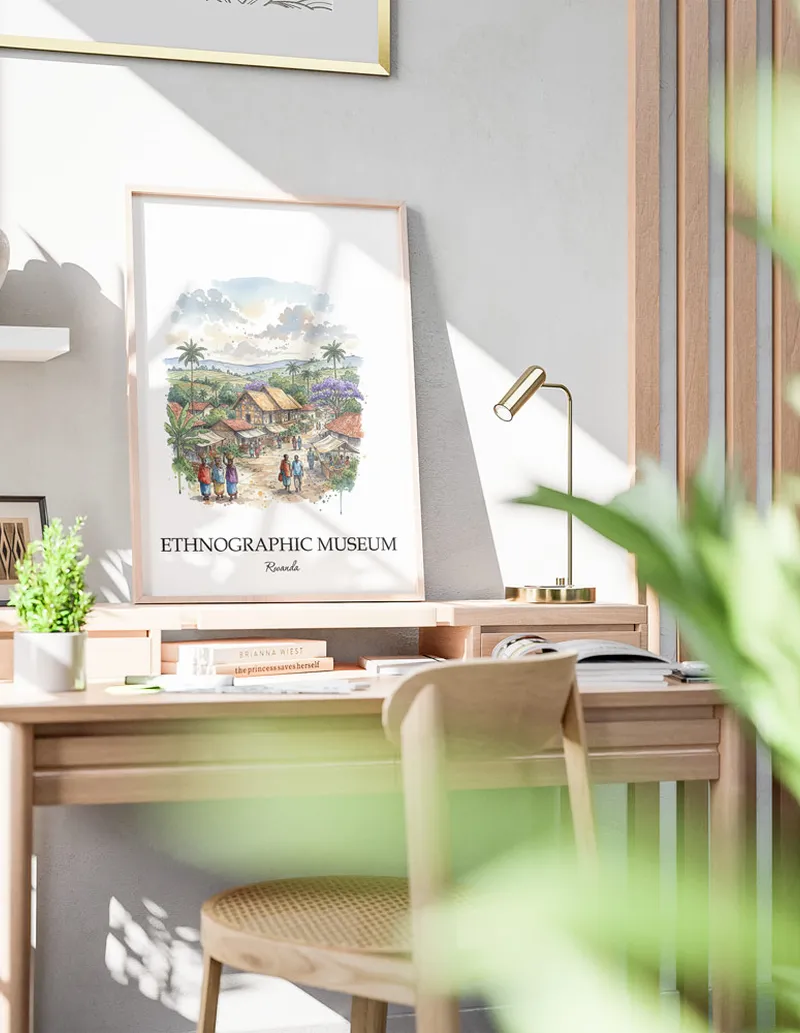 Framed wall art featuring Ethnographic Museum in Rwanda in a light wood frame leaning on the floor.