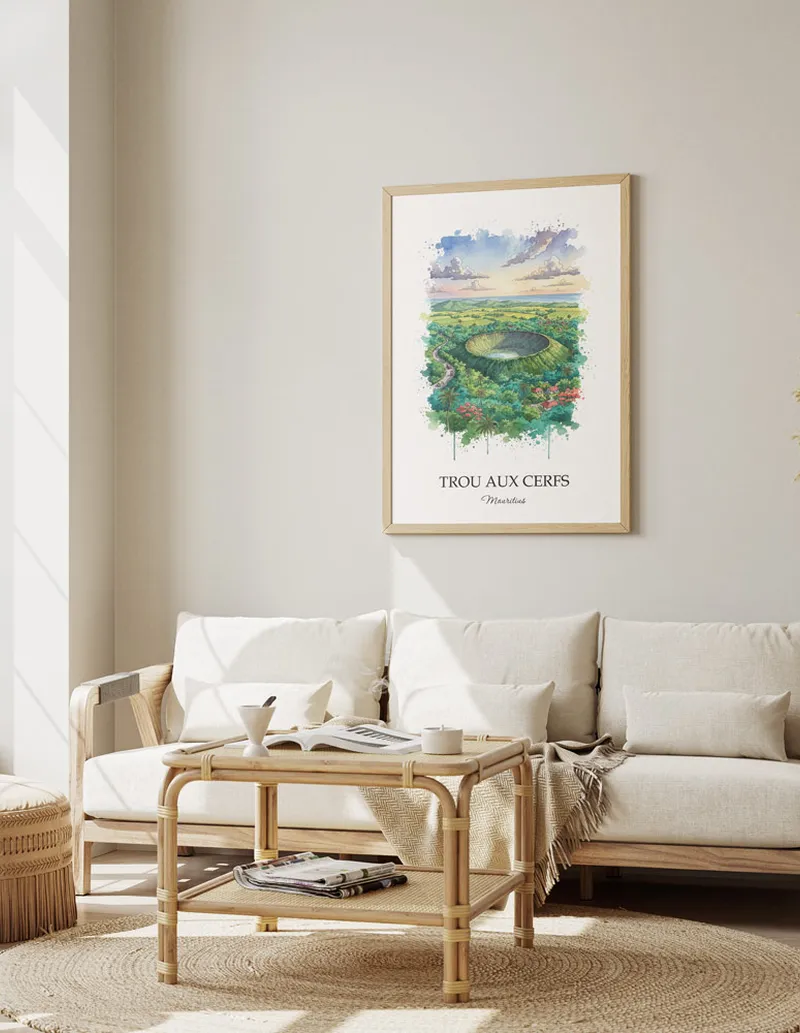 Vintage travel poster of Trou aux Cerfs, Mauritius in a light frame displayed above a sofa in a bright boho interior.