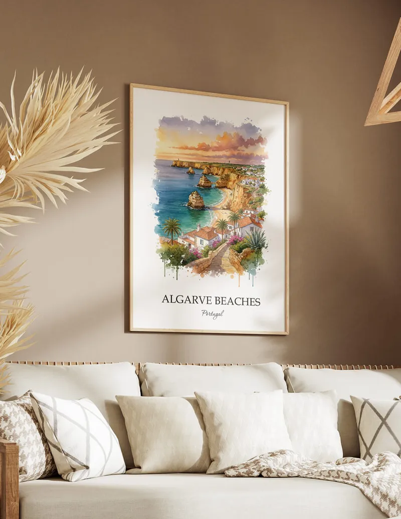 Vintage travel poster of Algarve Beaches, Portugal in a light frame displayed above a sofa in a bright boho interior.