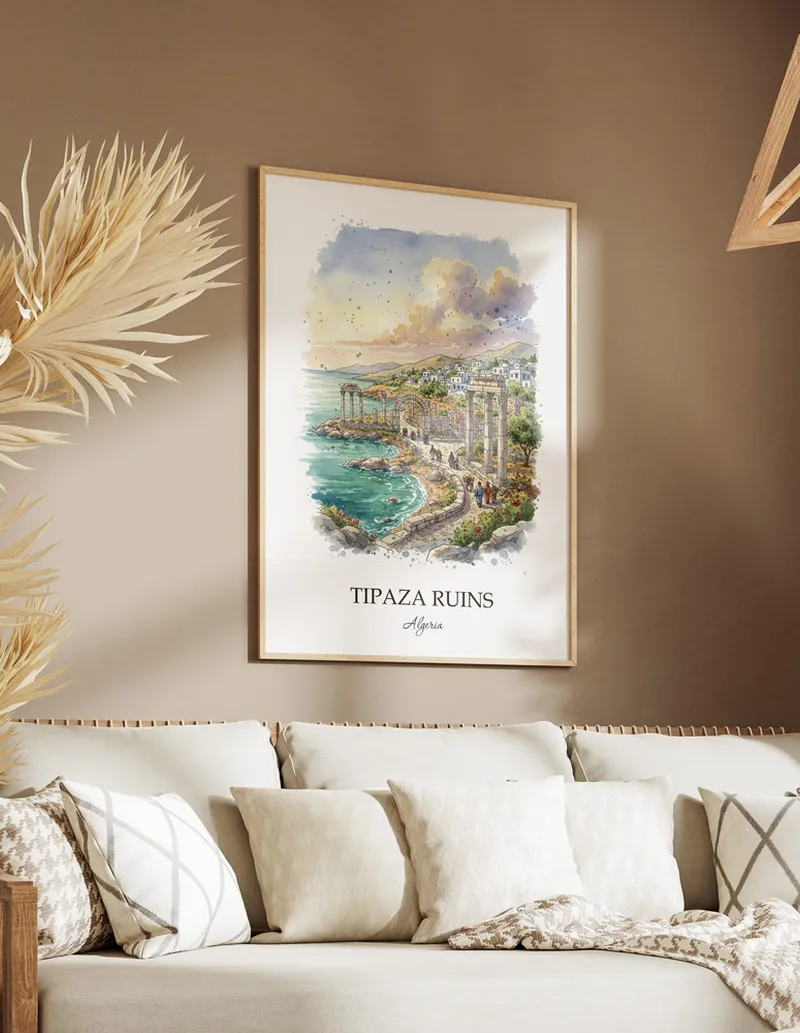 A gorgeous boho-inspired living space with a framed vintage travel poster of Tipaza Ruins in Algeria on display.