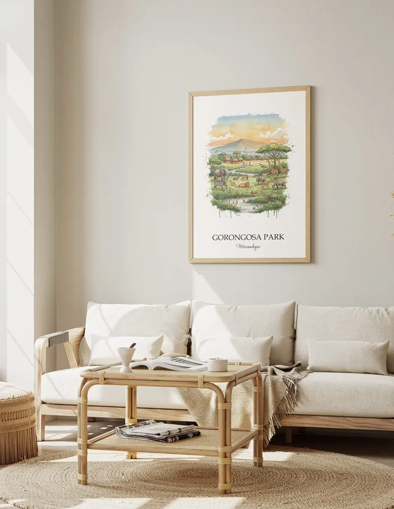 Vintage travel poster of Gorongosa Park, Mozambique in a light frame displayed above a sofa in a bright boho interior.