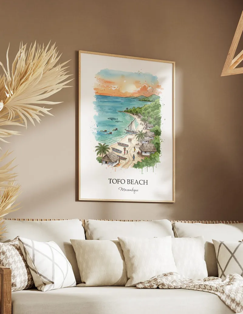 A gorgeous boho-inspired living space with a framed vintage travel poster of Tofo Beach in Mozambique on display.