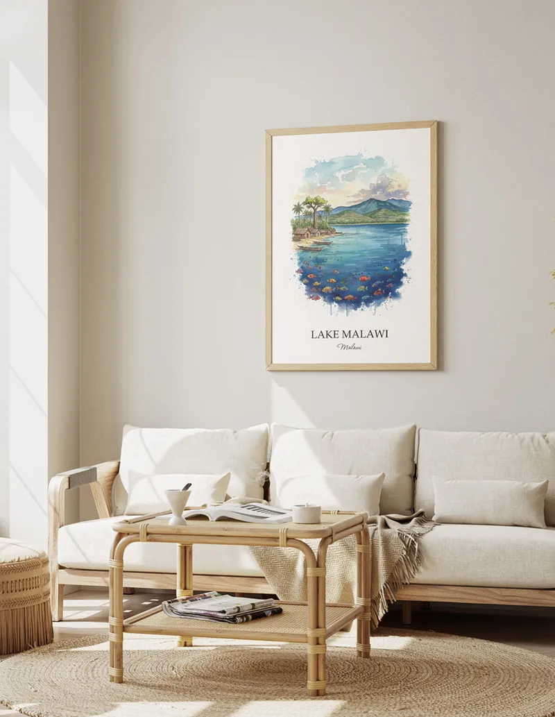 Vintage travel poster of Lake Malawi, Malawi in a light frame displayed above a sofa in a bright boho interior.