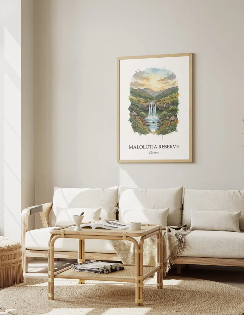 Vintage travel poster of Malolotja Reserve, Eswatini in a light frame displayed above a sofa in a bright boho interior.