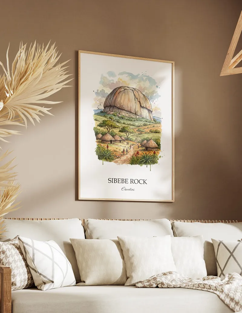 A gorgeous boho-inspired living space with a framed vintage travel poster of Sibebe Rock in Eswatini on display.