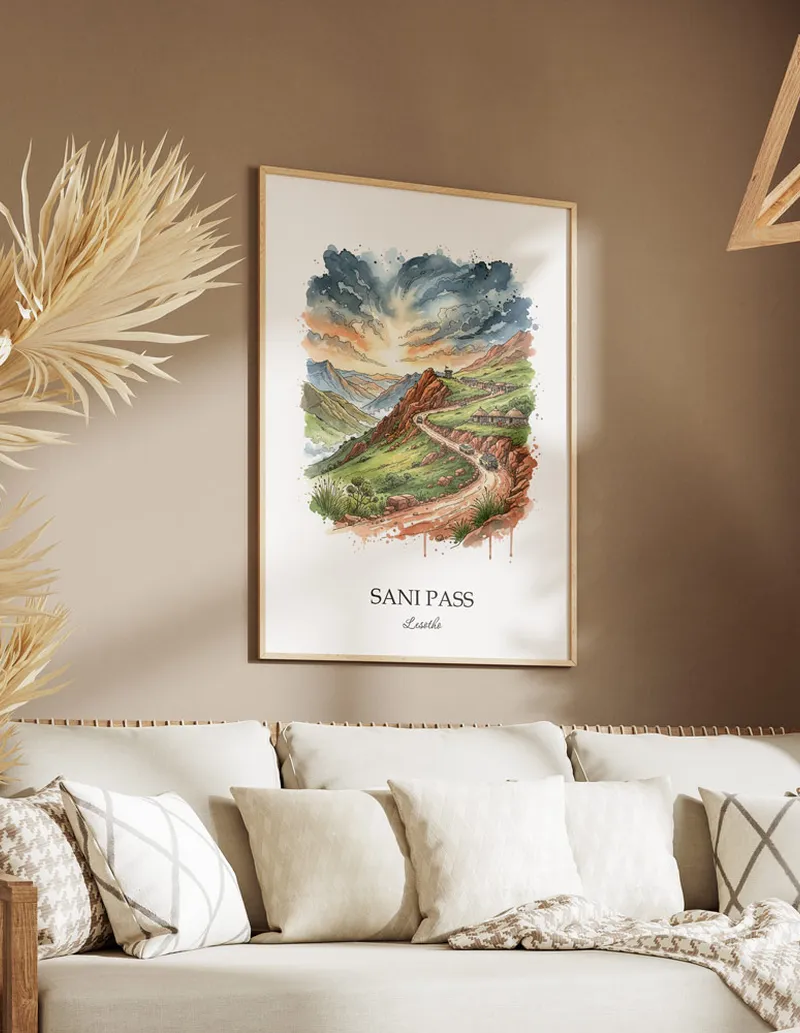 A gorgeous boho-inspired living space with a framed vintage travel poster of Sani Pass in Lesotho on display.