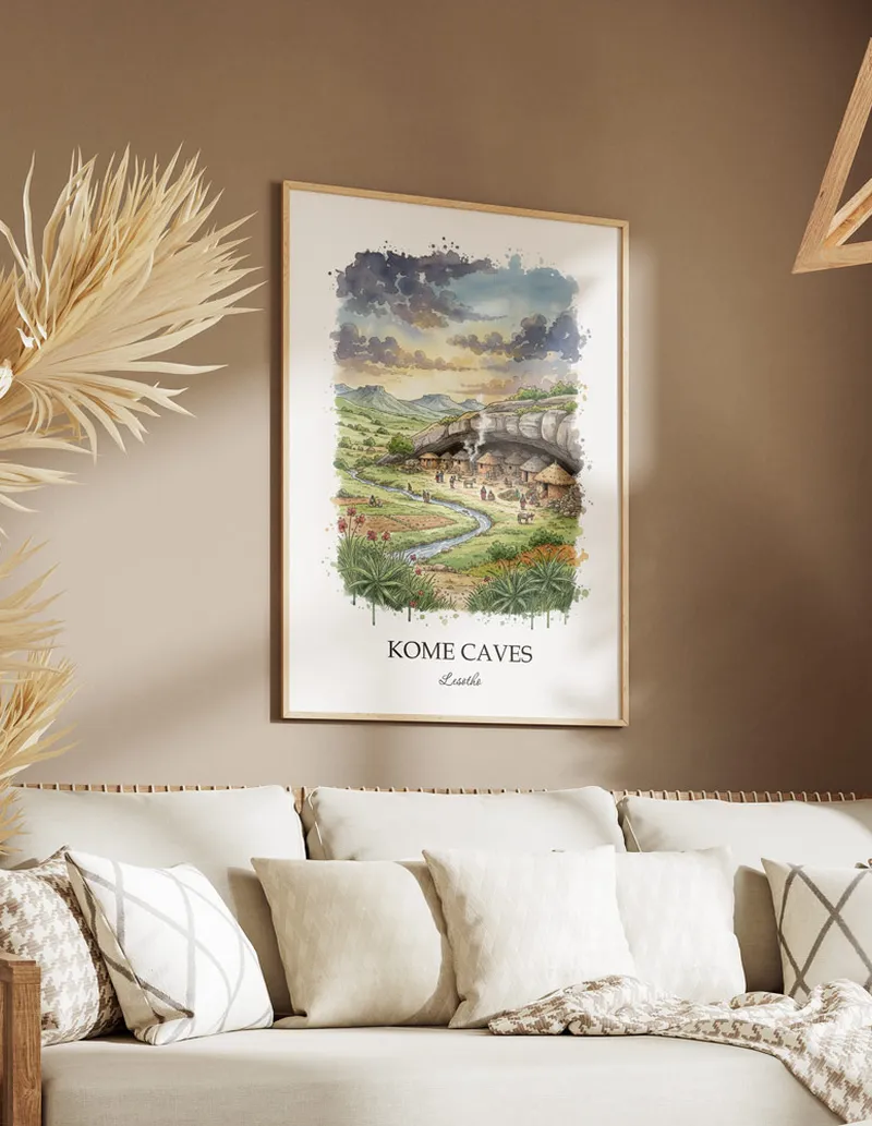 A gorgeous boho-inspired living space with a framed vintage travel poster of Kome Caves in Lesotho on display.