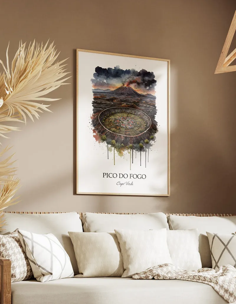 Cozy, well-lit workspace with a minimalist poster of Pico do Fogo, Cape Verde in a light frame sitting on the desk.