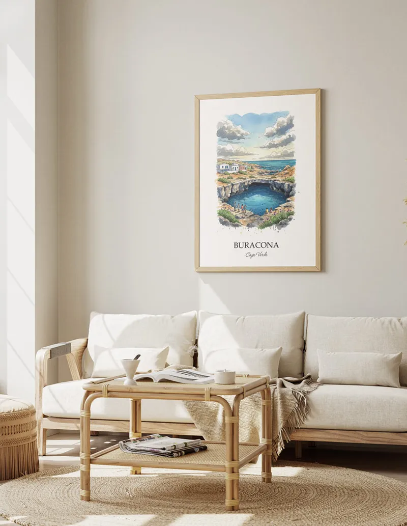 A gorgeous boho-inspired living space with a framed vintage travel poster of Buracona in Cape Verde on display.