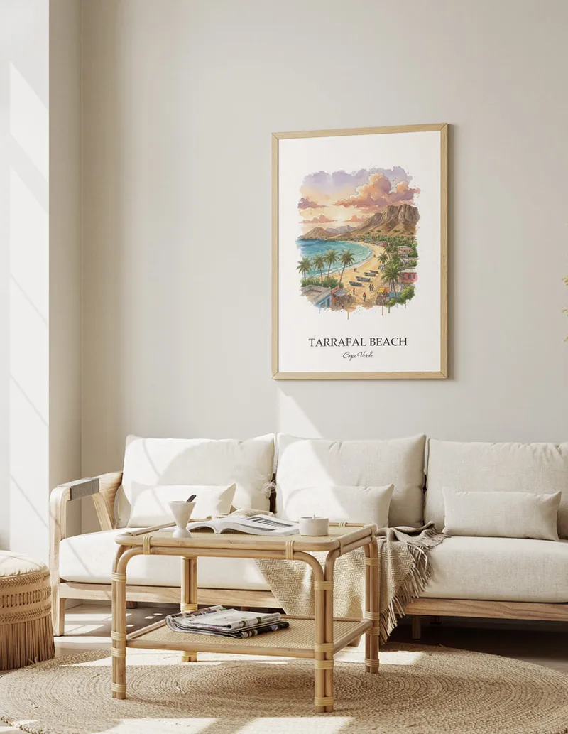 A gorgeous boho-inspired living space with a framed vintage travel poster of Tarrafal Beach in Cape Verde on display.