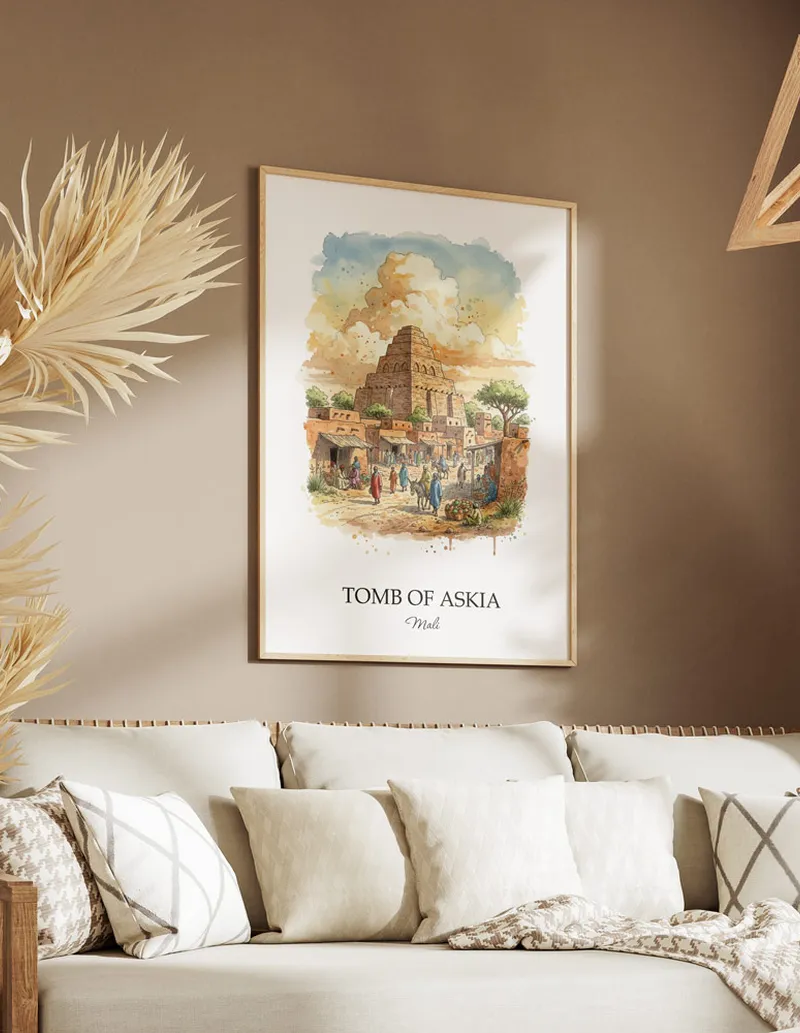 Cozy, well-lit workspace with a minimalist poster of Tomb of Askia, Mali in a light frame sitting on the desk.