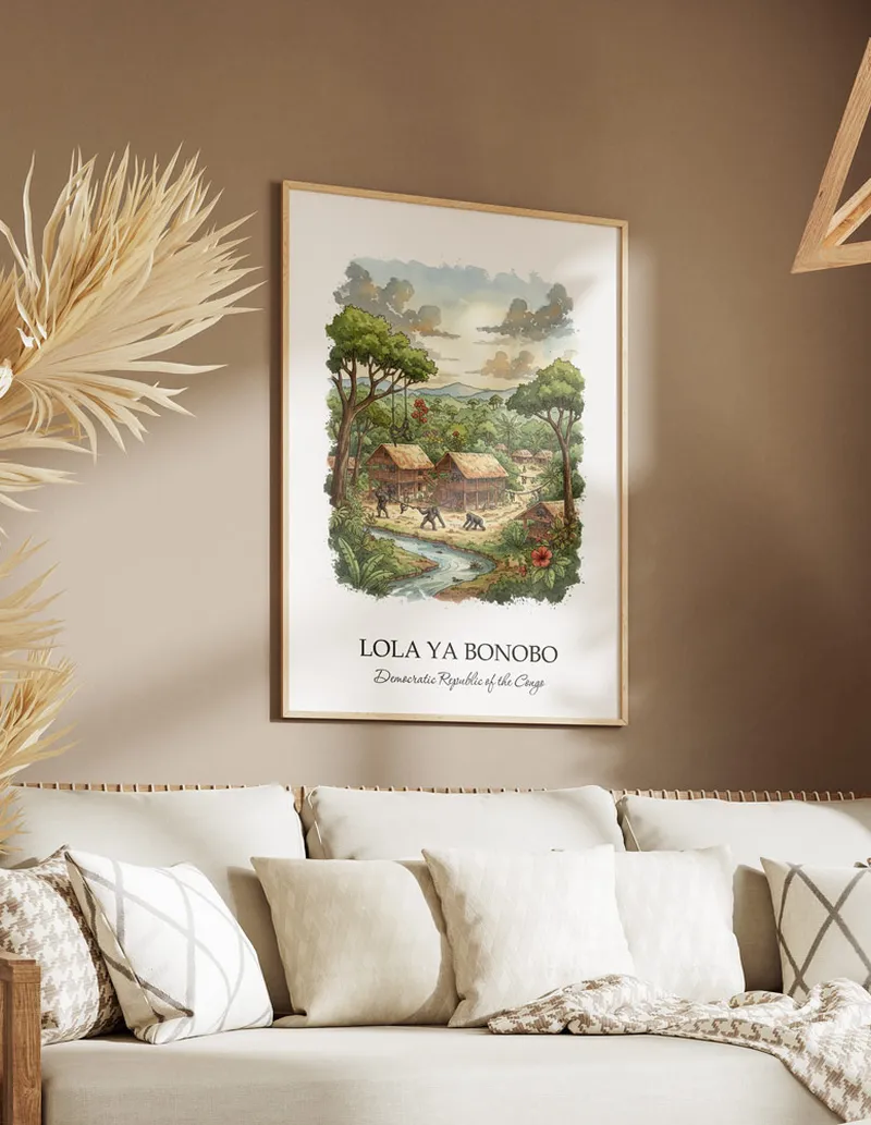 Cozy, well-lit workspace with a minimalist poster of Lola ya Bonobo, DRC in a light frame sitting on the desk.