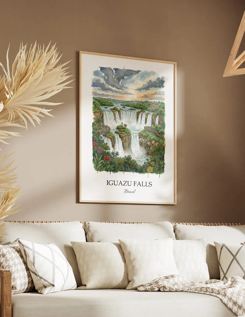 Cozy, well-lit workspace with a minimalist poster of Iguazu Falls, Brazil in a light frame sitting on the desk.